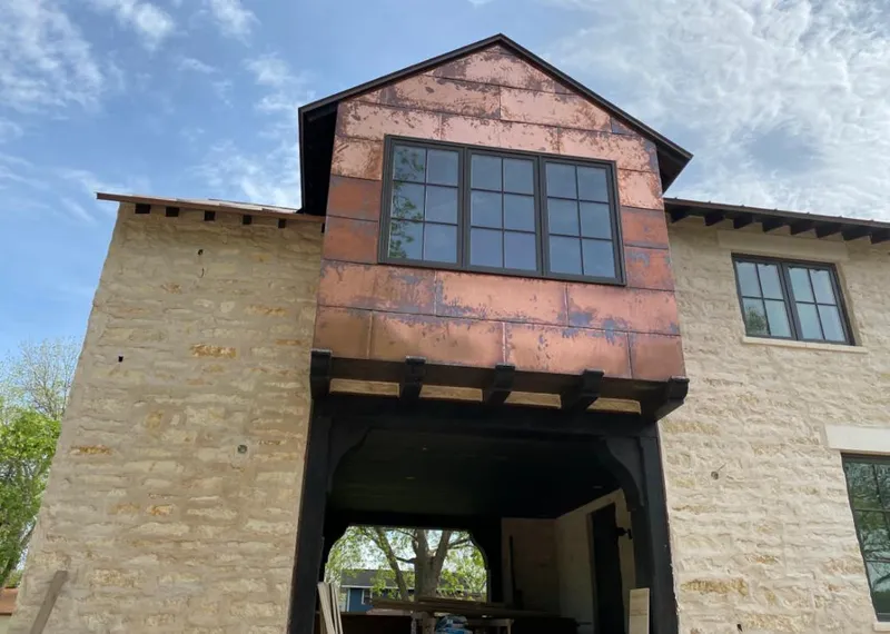 Copper metal panel facade on a stone building for Roof Repair in North Las Vegas